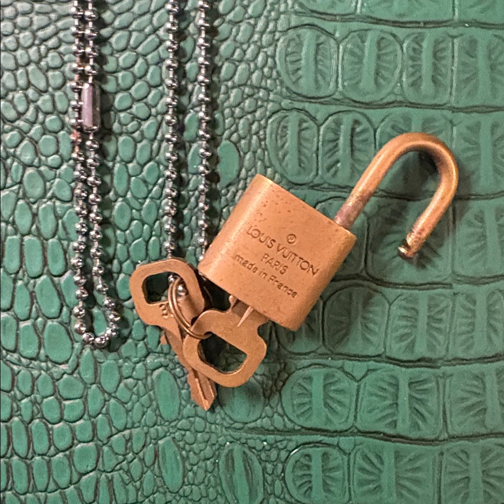Vintage Louis Vuitton gold padlock with set of keys on silver beaded chain